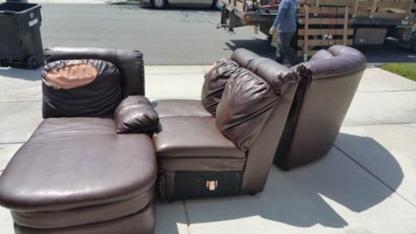 Three-piece leather sectional staged at the curb in San Diego